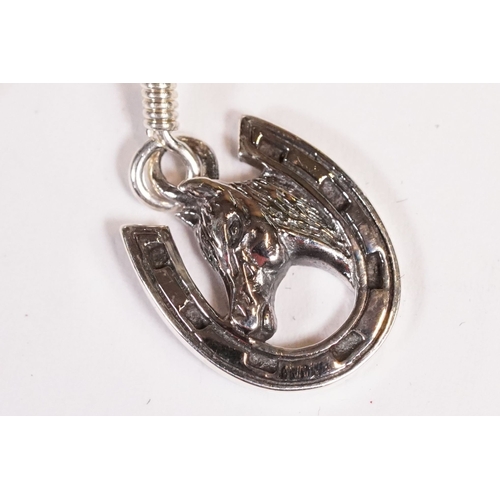 221 - Pair of silver horse and horse shoe earrings.