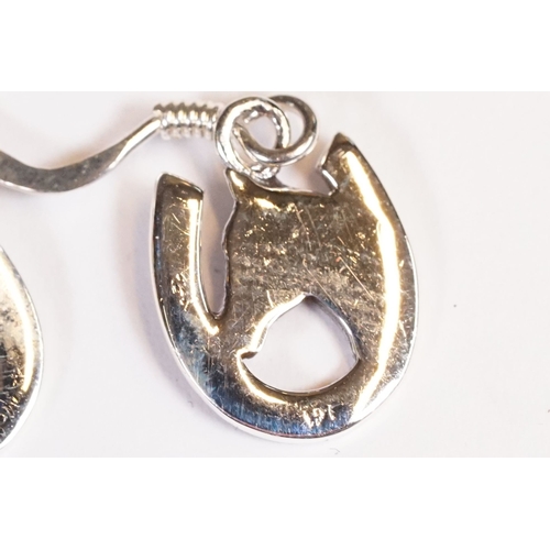 221 - Pair of silver horse and horse shoe earrings.