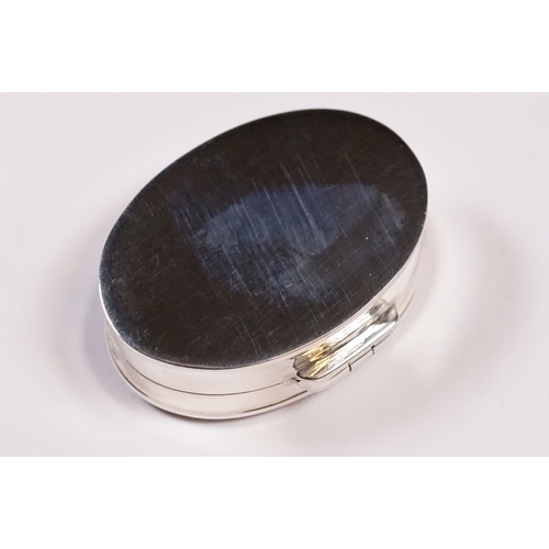 256 - Silver oval shaped pill box with enamel lid.