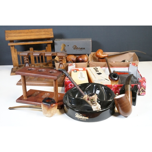 303 - A collection of mixed smoking pipes to include estate pipes, pipe racks, pipe holders, pipe rests...... 