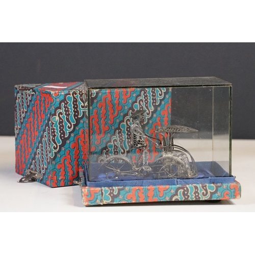 306 - A box of mixed collectables to include tinplate toy, swarovski ornaments, hip flask, oriental white ... 