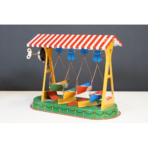 306 - A box of mixed collectables to include tinplate toy, swarovski ornaments, hip flask, oriental white ... 