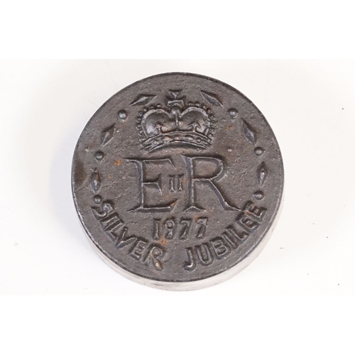 313 - A collection of four cast iron weights commemorating the 1977 silver jubilee of Queen Elizabeth II, ... 