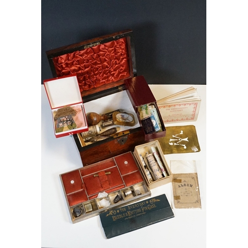 329 - An antique wooden fitted sewing box complete with contents to include needles, thimbles ...etc..