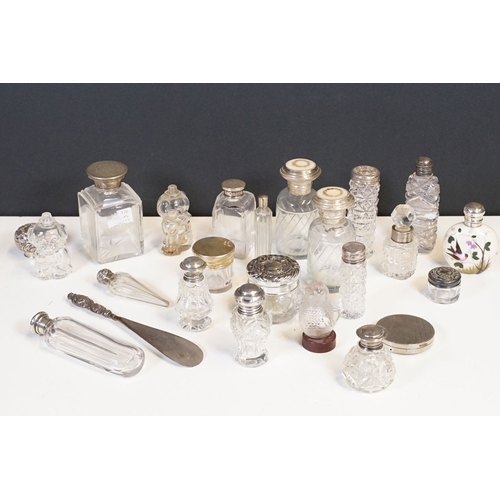 333 - A collection of vanity jars and bottles to include silver topped examples.