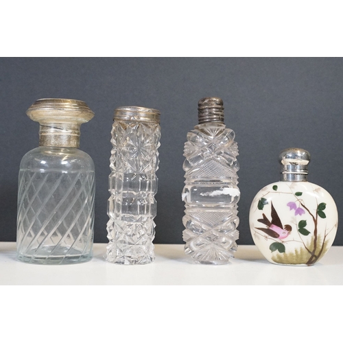 333 - A collection of vanity jars and bottles to include silver topped examples.