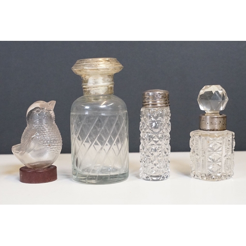 333 - A collection of vanity jars and bottles to include silver topped examples.