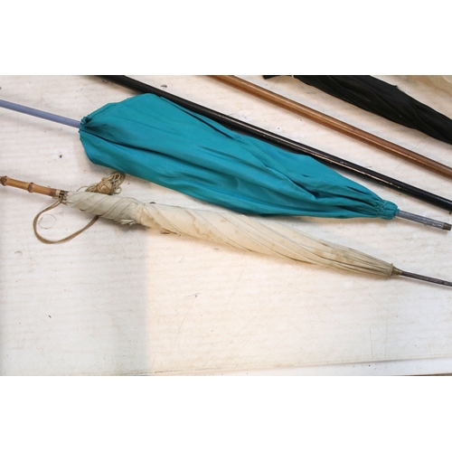 335 - Victorian parasol, with carved ebonised handle and black silk canopy, a Victorian parasol with carve... 