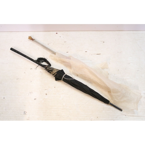 335 - Victorian parasol, with carved ebonised handle and black silk canopy, a Victorian parasol with carve... 