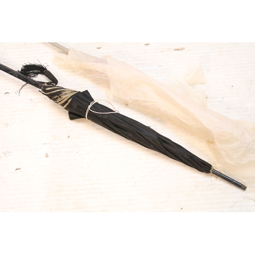335 - Victorian parasol, with carved ebonised handle and black silk canopy, a Victorian parasol with carve... 