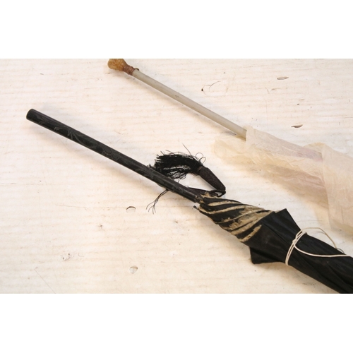 335 - Victorian parasol, with carved ebonised handle and black silk canopy, a Victorian parasol with carve... 