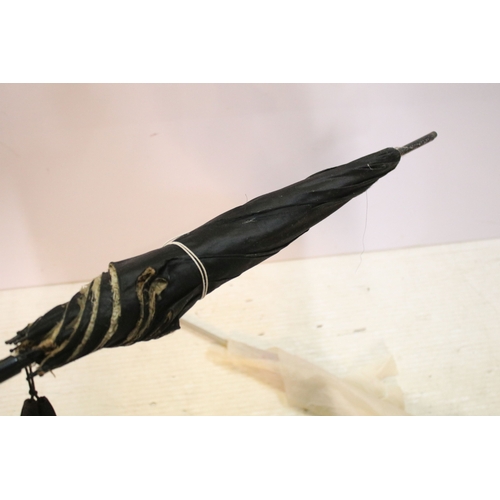 335 - Victorian parasol, with carved ebonised handle and black silk canopy, a Victorian parasol with carve... 