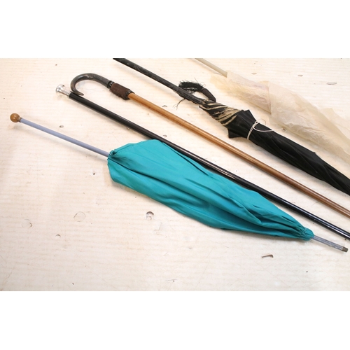 335 - Victorian parasol, with carved ebonised handle and black silk canopy, a Victorian parasol with carve... 