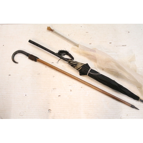 335 - Victorian parasol, with carved ebonised handle and black silk canopy, a Victorian parasol with carve... 