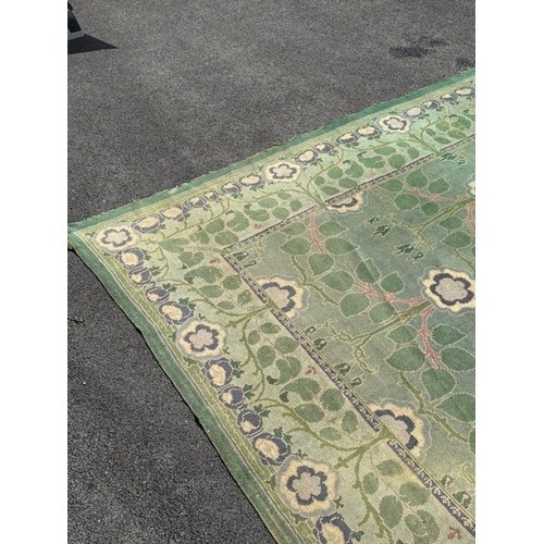 656 - Green ground rug, possibly a Donegal carpet, having intertwined foliage design to pond and border, 4... 