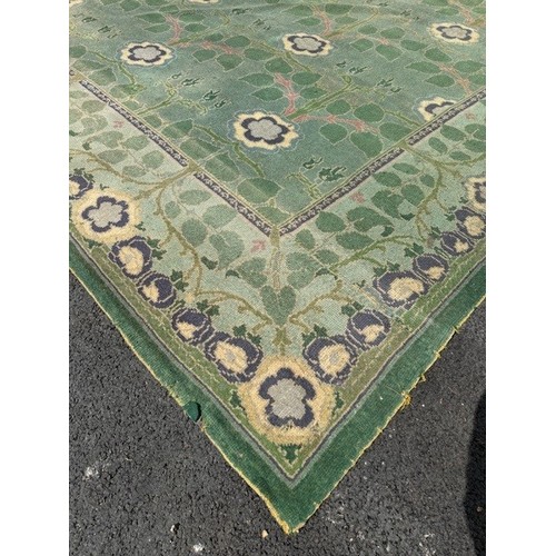 656 - Green ground rug, possibly a Donegal carpet, having intertwined foliage design to pond and border, 4... 