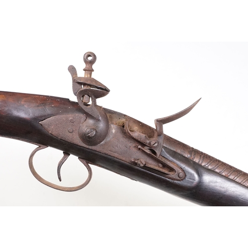 A Victorian flintlock short rifle with ornate design, queens crown mark ...
