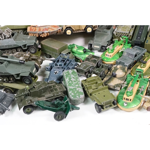 1440 - Over 75 Mid 20th C play worn diecast and metal military models to include2 x boxed Solido examples (... 