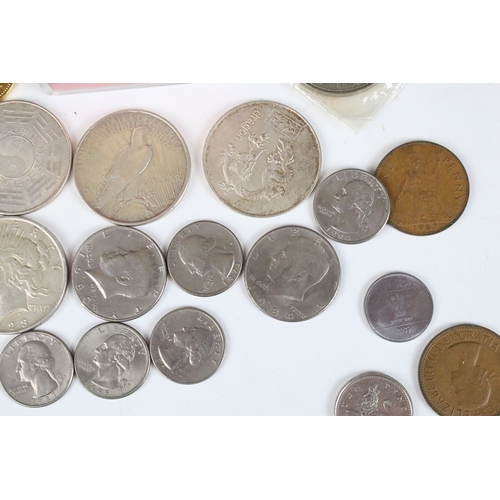 425 - A small collection of coins to include two United States of America silver peace dollars.