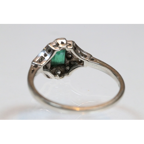 30 - Art Deco 18ct gold, emerald and diamond panel ring. The ring being set with a rectangular step cut e... 