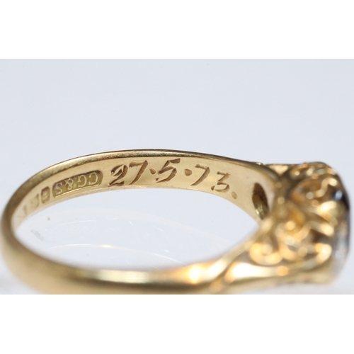 36 - 18ct gold, garnet and diamond three stone ring. The ring being set with a round cut red garnet to ce... 