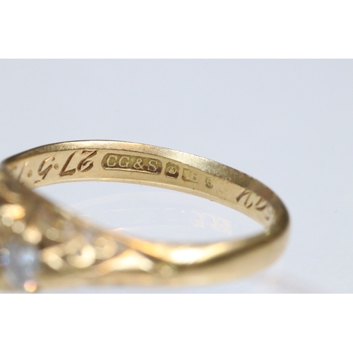 36 - 18ct gold, garnet and diamond three stone ring. The ring being set with a round cut red garnet to ce... 