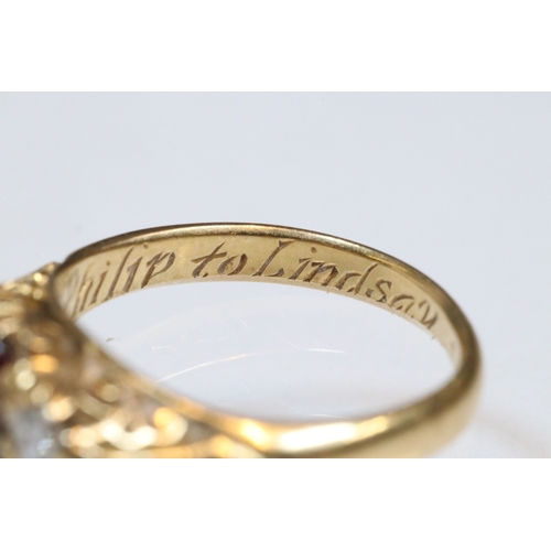 36 - 18ct gold, garnet and diamond three stone ring. The ring being set with a round cut red garnet to ce... 
