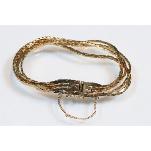 43 - 9ct gold four strand bracelet. The bracelet having a tongue in groove clasp with safety chain. Impor... 