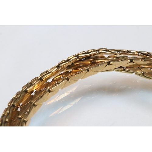 43 - 9ct gold four strand bracelet. The bracelet having a tongue in groove clasp with safety chain. Impor... 