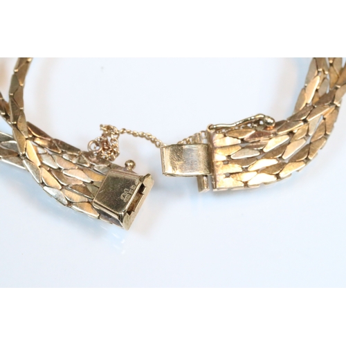 43 - 9ct gold four strand bracelet. The bracelet having a tongue in groove clasp with safety chain. Impor... 