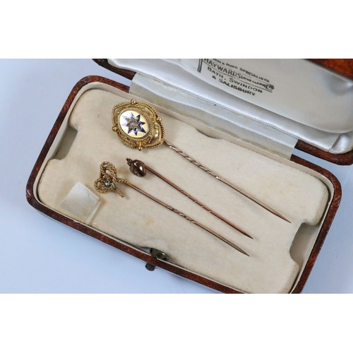185 - Group of three 19th Century stick pins to include a yellow metal example with pearl and enamel finia... 