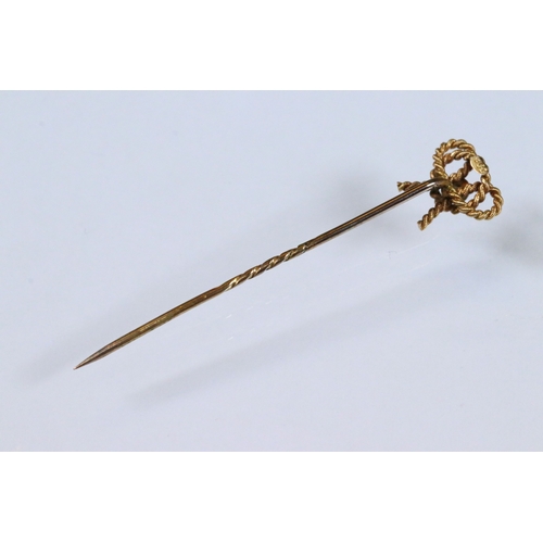 185 - Group of three 19th Century stick pins to include a yellow metal example with pearl and enamel finia... 