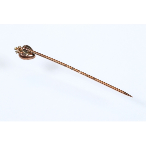 185 - Group of three 19th Century stick pins to include a yellow metal example with pearl and enamel finia... 