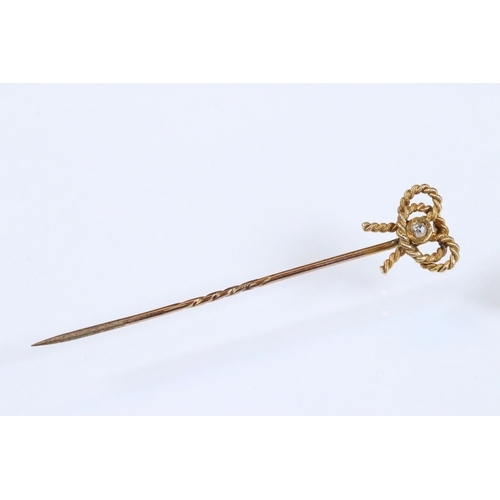 185 - Group of three 19th Century stick pins to include a yellow metal example with pearl and enamel finia... 