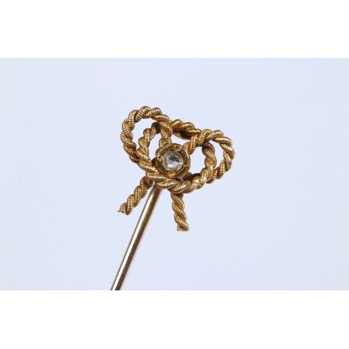 185 - Group of three 19th Century stick pins to include a yellow metal example with pearl and enamel finia... 