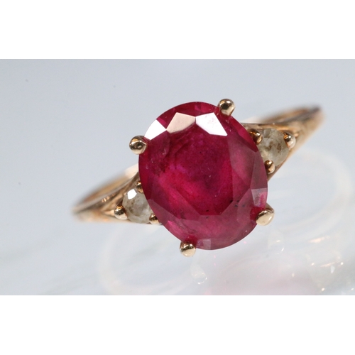191 - 10ct gold, synthetic ruby and white stone ring. The ring being set with an oval cut synthetic ruby f... 