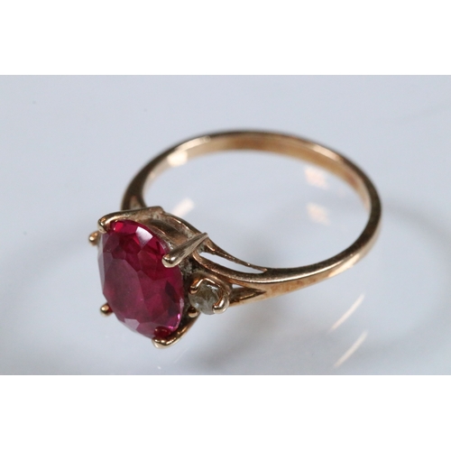 191 - 10ct gold, synthetic ruby and white stone ring. The ring being set with an oval cut synthetic ruby f... 