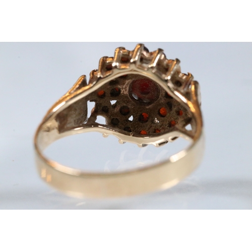 195 - 9ct gold and garnet cluster ring. The ring having a round head set with round cut garnets with textu... 
