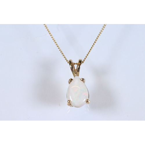 227 - 9ct gold and pendant necklace having a fine link chain with a pear cut opal cabochon (marked marked ... 