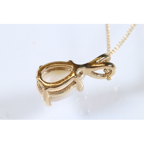 227 - 9ct gold and pendant necklace having a fine link chain with a pear cut opal cabochon (marked marked ... 