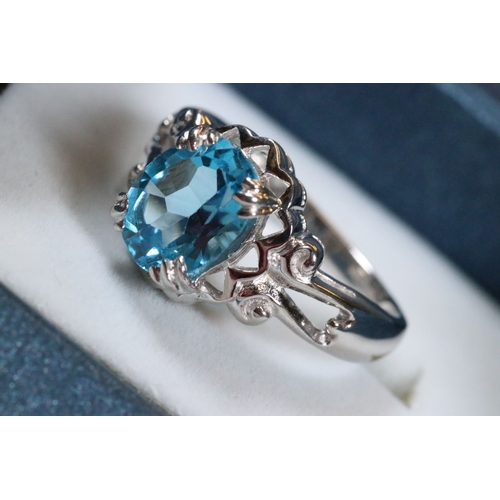 234 - 9ct white gold and blue topaz dress ring being set with an oval mixed cut topaz with pierced and scr... 