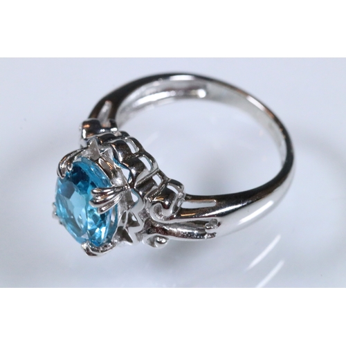234 - 9ct white gold and blue topaz dress ring being set with an oval mixed cut topaz with pierced and scr... 