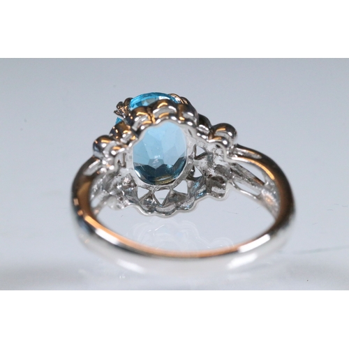 234 - 9ct white gold and blue topaz dress ring being set with an oval mixed cut topaz with pierced and scr... 