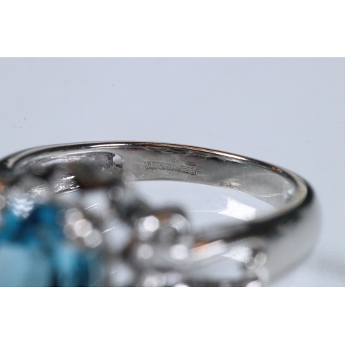 234 - 9ct white gold and blue topaz dress ring being set with an oval mixed cut topaz with pierced and scr... 