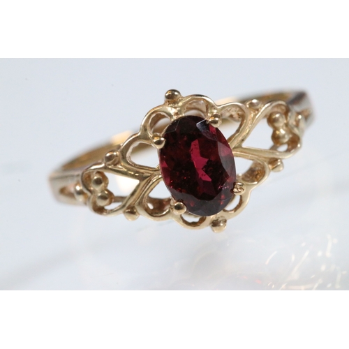 236 - 9ct gold and and pink tourmaline ring. The ring being set with an oval mixed cut tourmaline within a... 