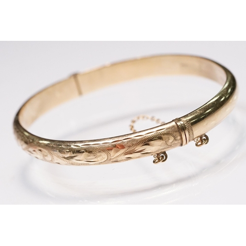 186 - 9ct gold bangle bracelet with engraved exterior and hinged opening. Hallmarked Birmingham 1990. Meas... 