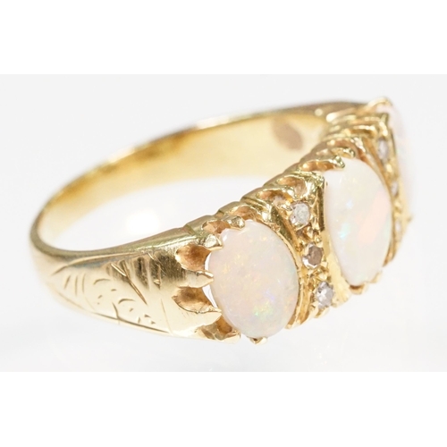 24 - 18ct gold, opal and diamond ring. The ring being set with three oval opal cabochons with six diamond... 