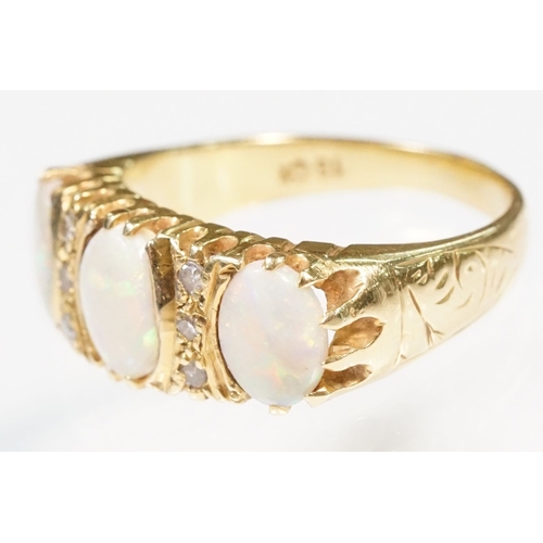 24 - 18ct gold, opal and diamond ring. The ring being set with three oval opal cabochons with six diamond... 