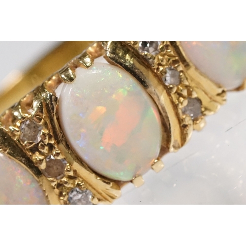 24 - 18ct gold, opal and diamond ring. The ring being set with three oval opal cabochons with six diamond... 