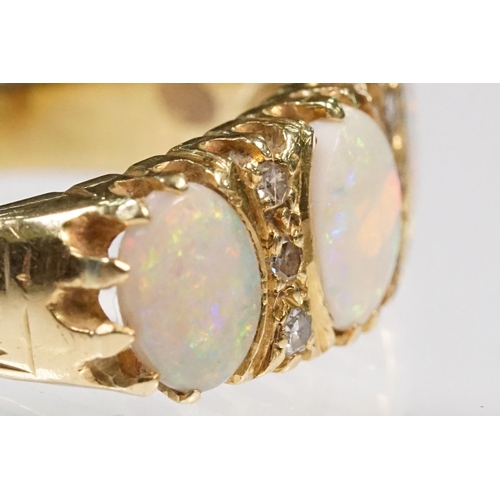 24 - 18ct gold, opal and diamond ring. The ring being set with three oval opal cabochons with six diamond... 